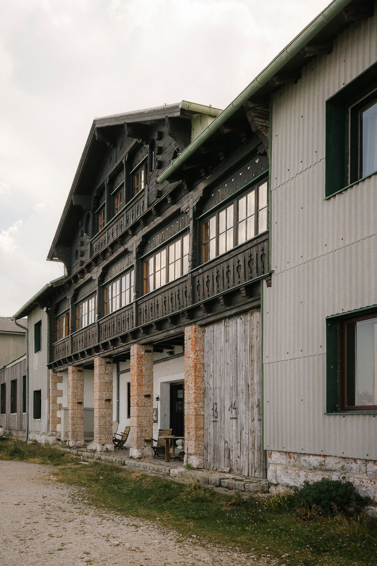 Historic facade with a wooden balcony at the Hochschneeberg Mountain Lodge