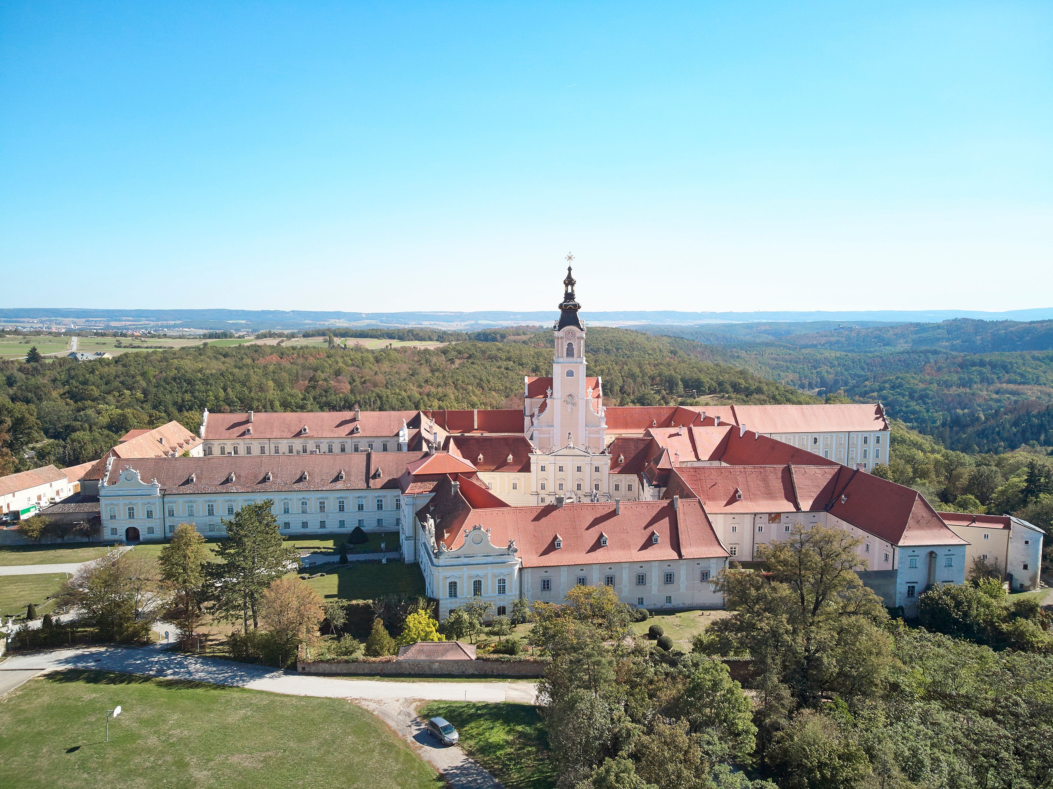 Aerial view of Altenburg Abbey in the middle of a green landscape.