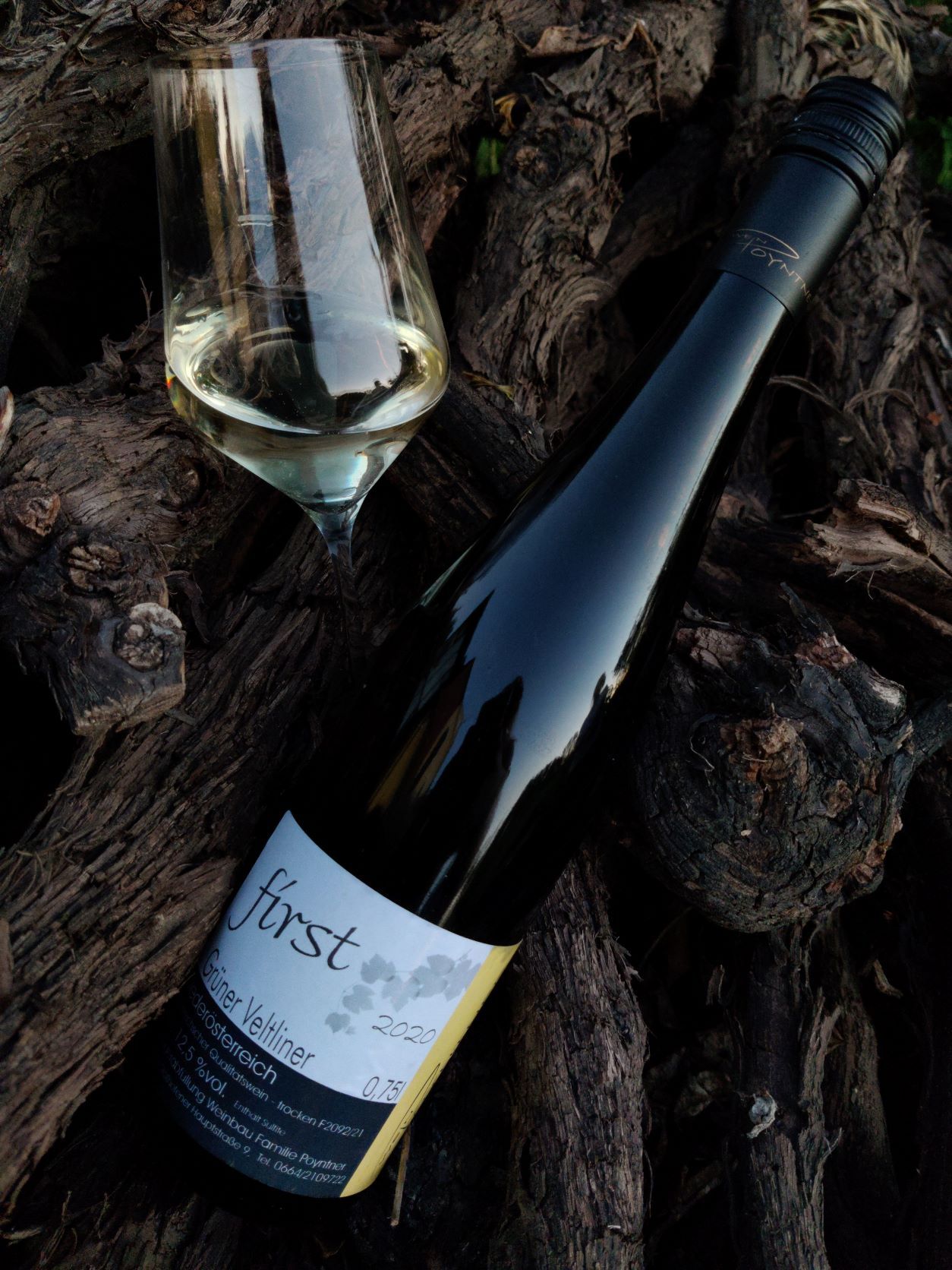 Wine bottle and glass on wood.