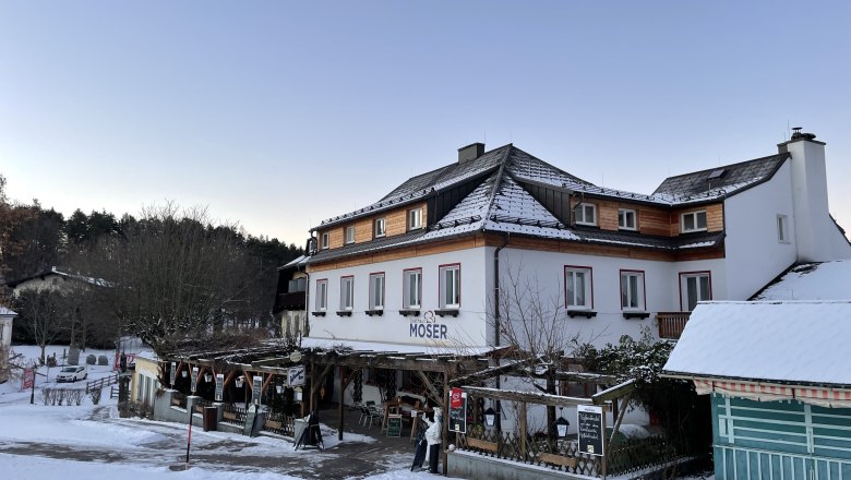 Gasthaus Moser covered in snow in winter.