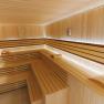 Interior view of a modern sauna with wooden benches and soft lighting.
