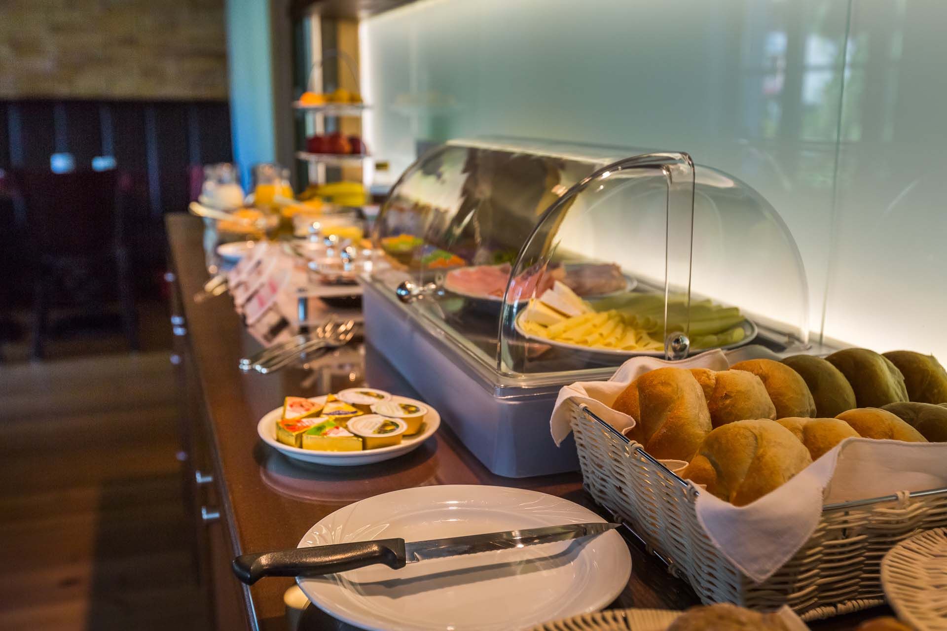 A rich breakfast buffet with bread rolls, cold cuts and cheese.