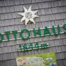 Sign of the Ottohaus at 1644 meters altitude with Alpine Club logo and map.