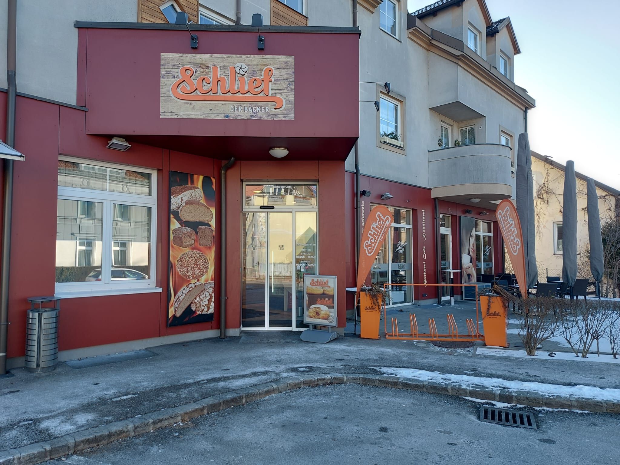 Exterior view of the Schlief Bakery with a sign featuring its logo