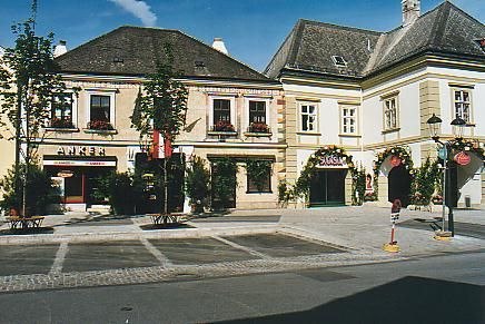 Historic buildings with stores and decorative facades on a sunny day.