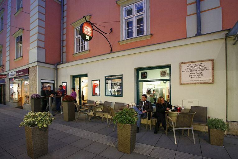 Street café with people sitting outside.