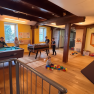 Children play in a playroom with a pool table, table soccer and building blocks.