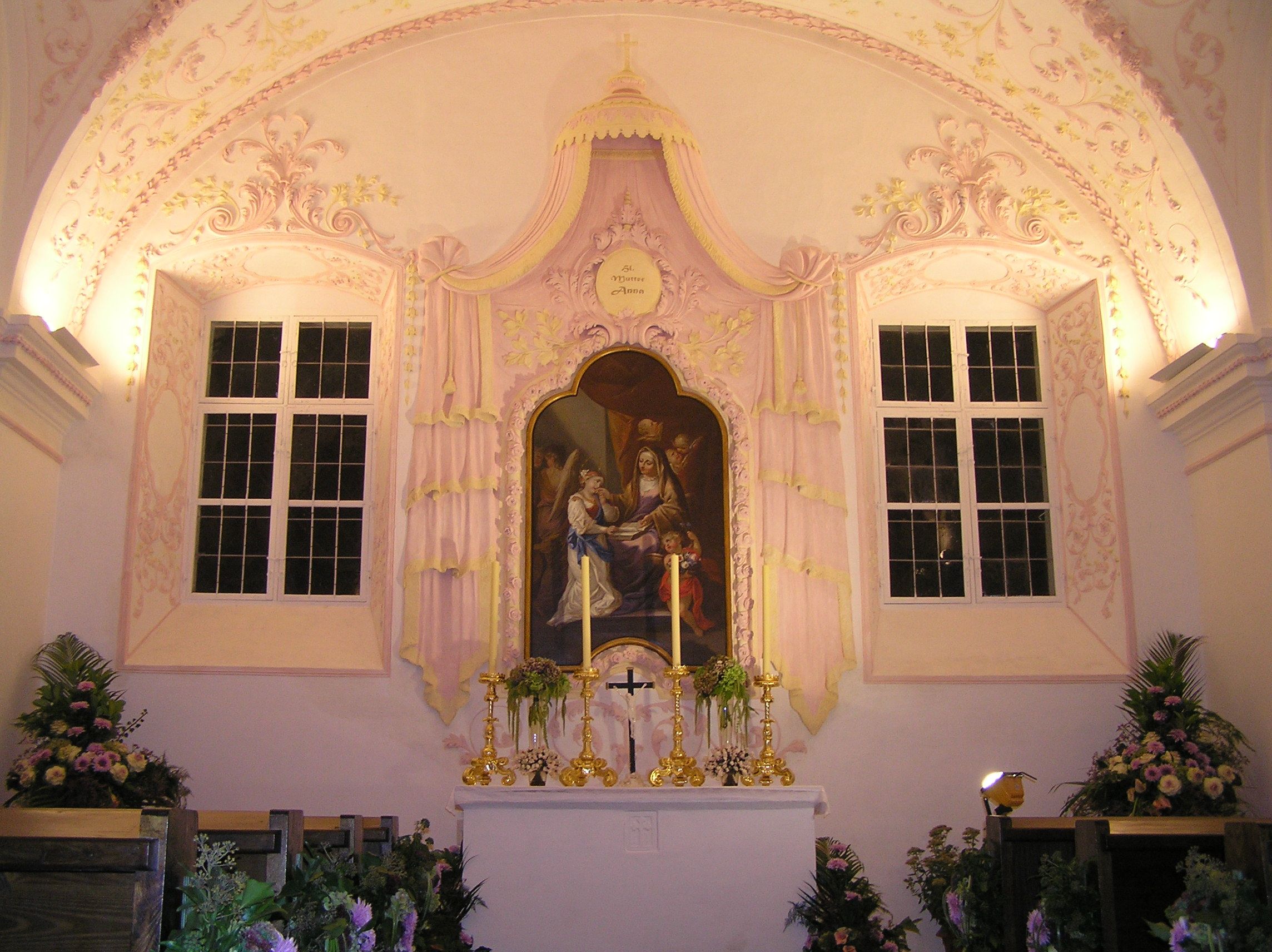 Interior view of a chapel with altar and religious painting.