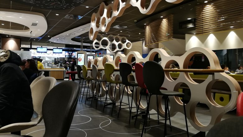 Interior view of a McDonald's restaurant with modern furniture and decorations.