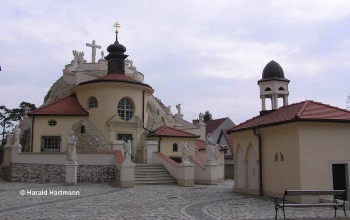 Church in Maria Lanzendorf with statues and bell tower.