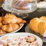 A richly laid breakfast table with pastries and Danish pastries
