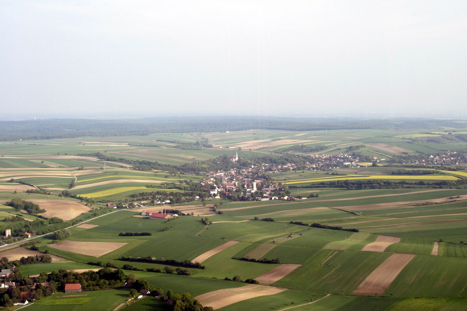 Aerial view of Hochleithen, surrounded by fields and forests.
