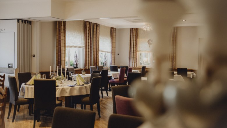 Elegant dining room with laid tables and candles.