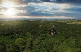 Panoramic view of the Koliskowarte in the middle of a dense forest at sunset.