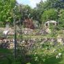Terraced garden with stone walls and pavilion.