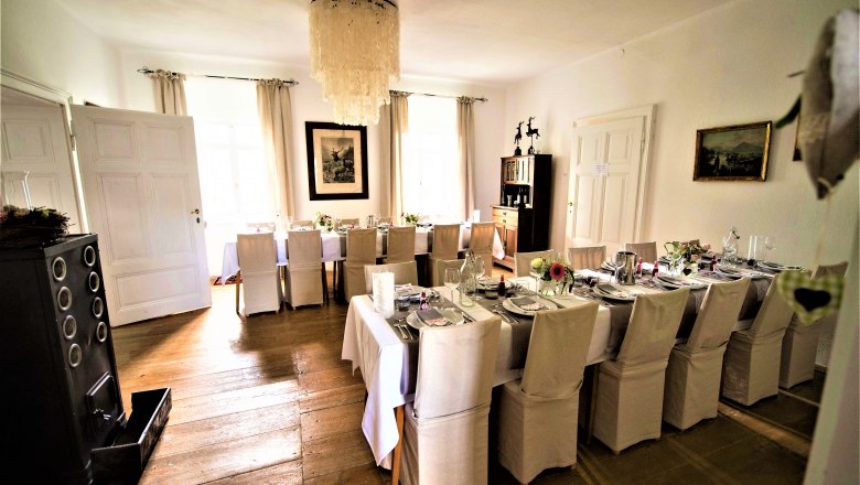 Elegant dining room with table setting and chandelier.