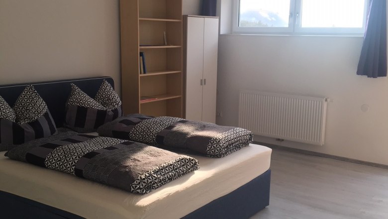Bedroom with double bed, wooden floor and window