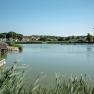 A quiet pond with a jetty and surrounding houses in Poysdorf.
