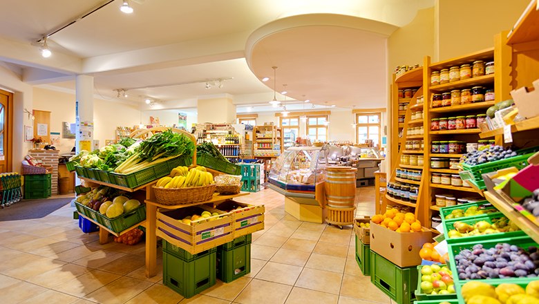 Interior view of an organic store with fresh fruit and vegetables.