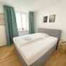 Double room with wooden floor and large window