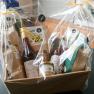 Gift basket with regional products, wrapped in foil, on a table.