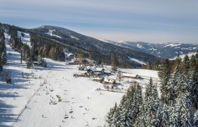 Winter landscape with ski lift and snow-covered mountains in M&ouml;nichkirchen.