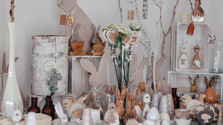 Decorative Easter bunnies and spring decorations arranged on a table.