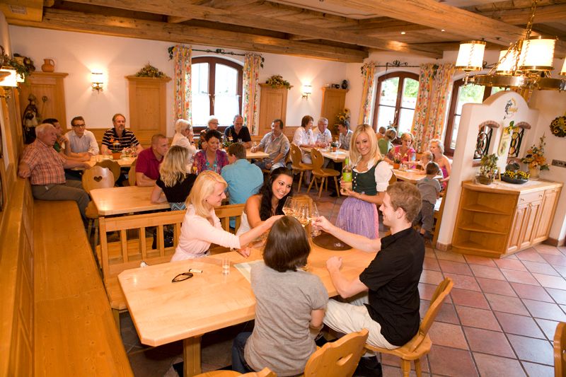 People in a traditional restaurant toasting with wine.