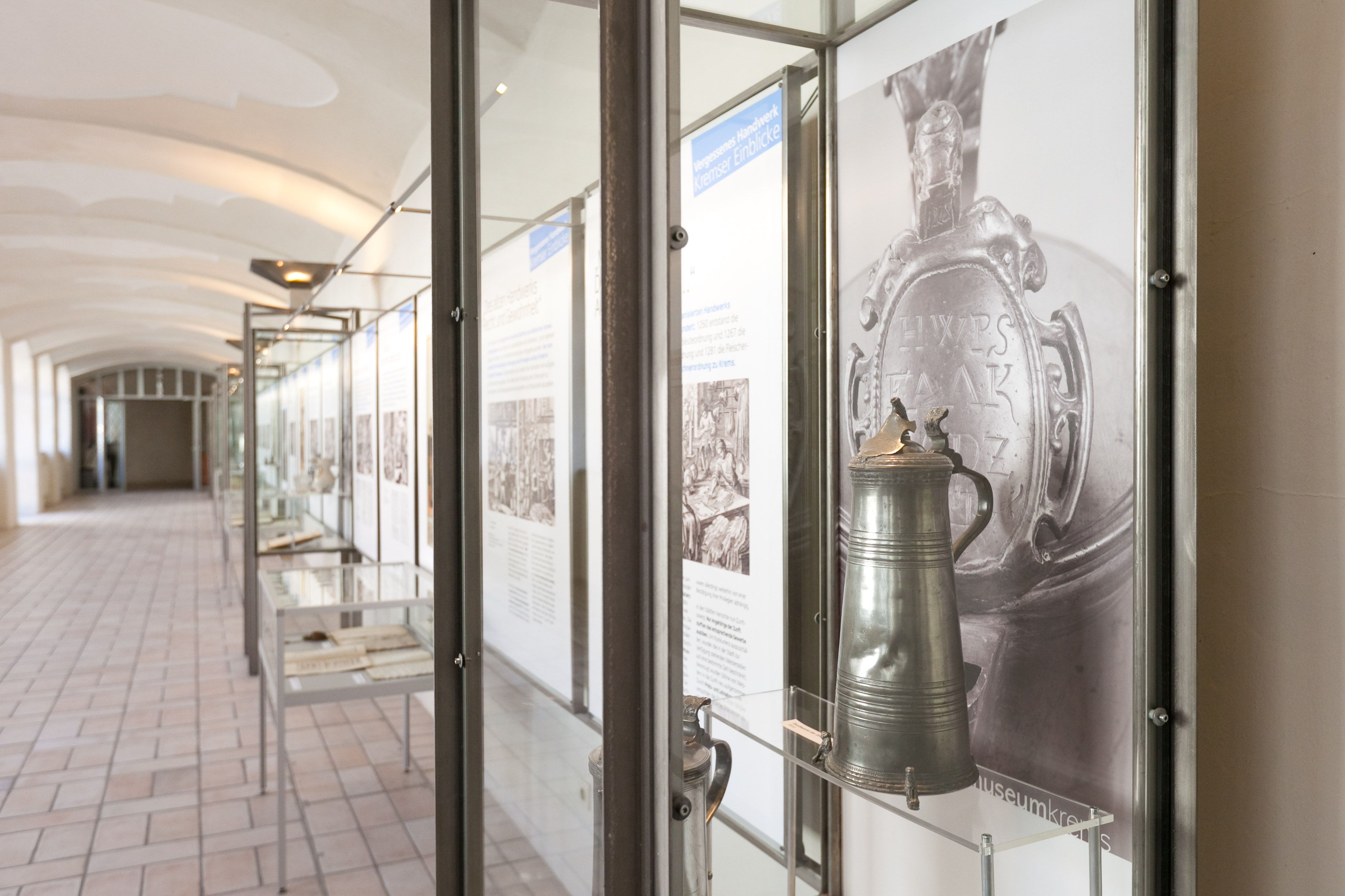 Exhibition in the Krems Museum with historical objects in glass cases.