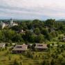 Aerial view of Grafenegg Cottages and castle surrounded by trees.