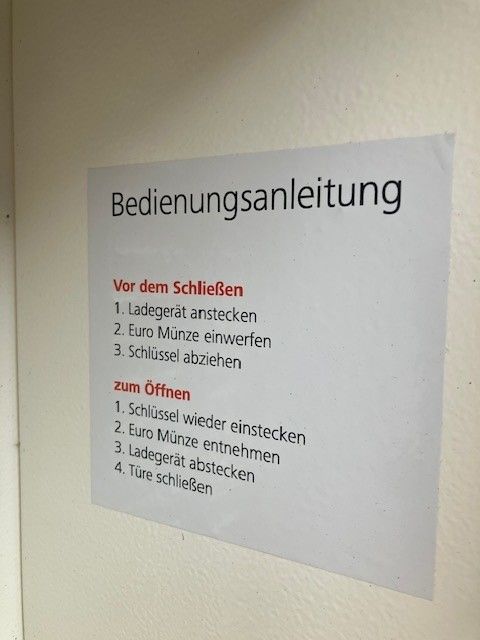 Instructions for an e-bike charging station with steps for closing and opening.