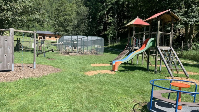 Playground with climbing frame, slide and carousel in the Falkenstein Nature Park.