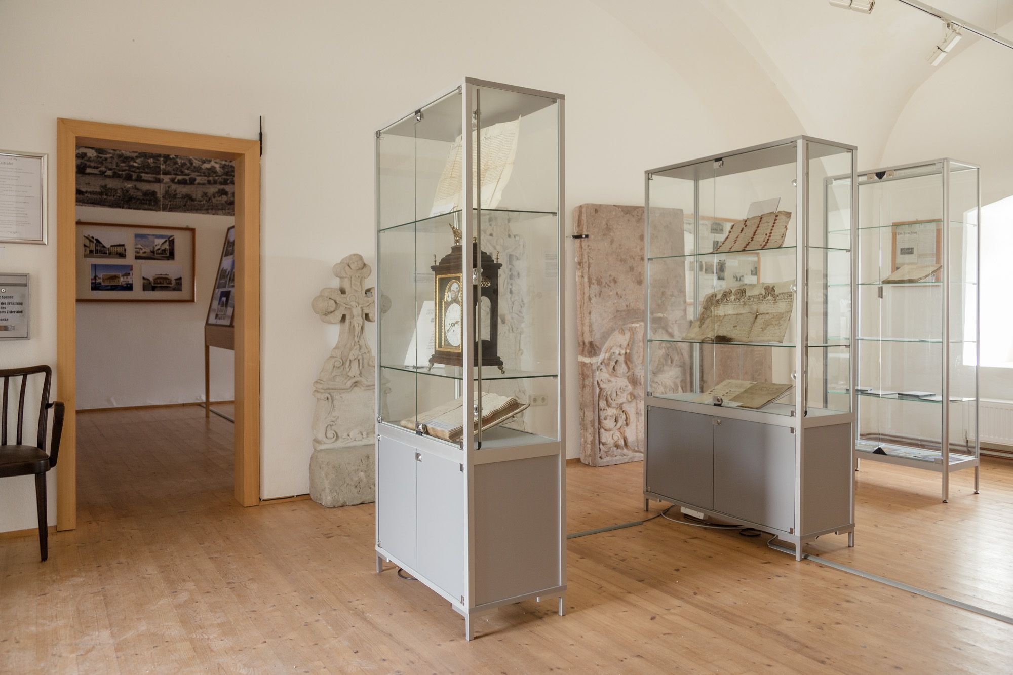 Interior view of a museum with display cases containing historical documents and objects.