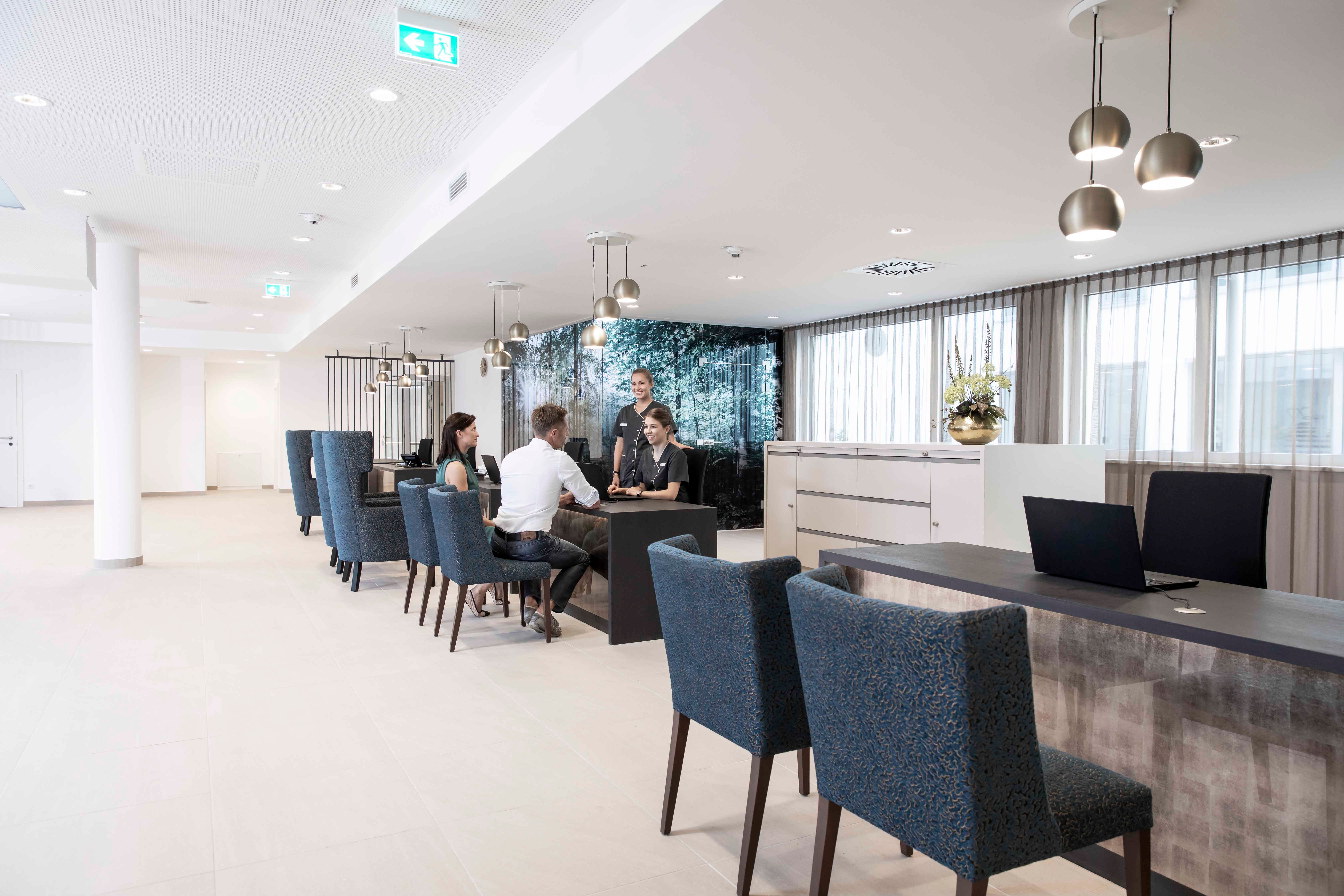 Modern reception with people sitting at a table and talking.