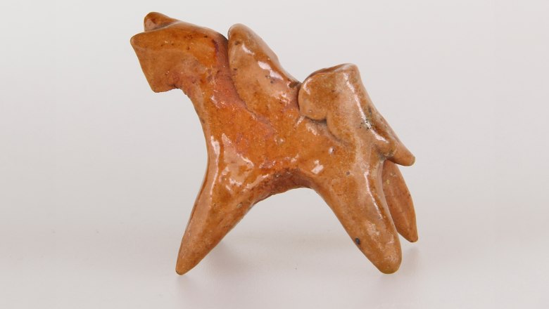 Ceramic figure of a stylized horse with rider.