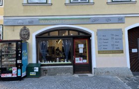 Store entrance with a vending machine in front of it
