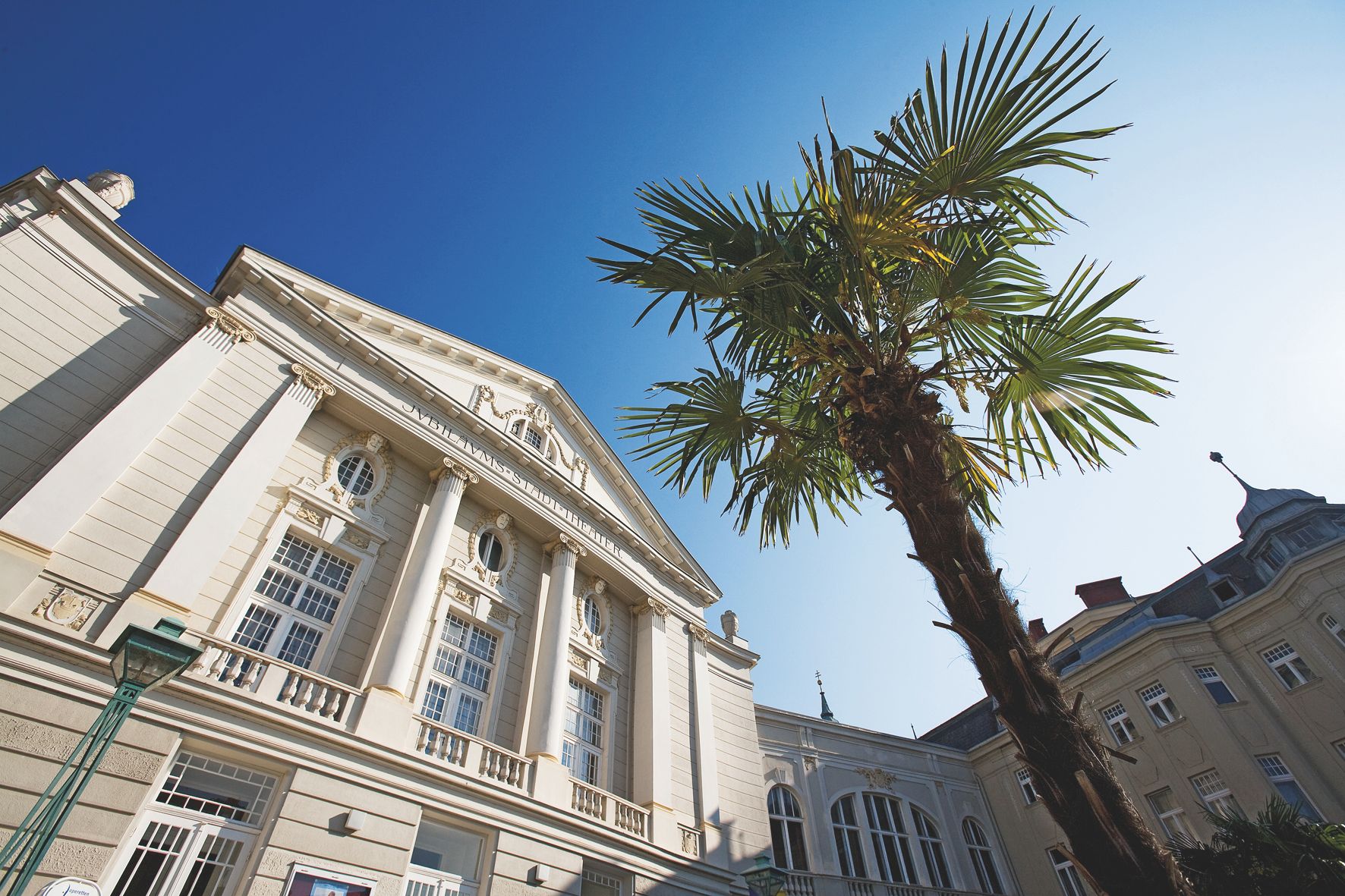 The Stadttheater Baden at night, illuminated with warm light.