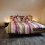 Double bed with colorful striped bed linen
