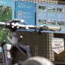 A bicycle stands in front of an information board with hiking and cycling trails in the Vienna Alps.