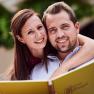 A smiling couple holding a menu card at the wine tavern Burger.