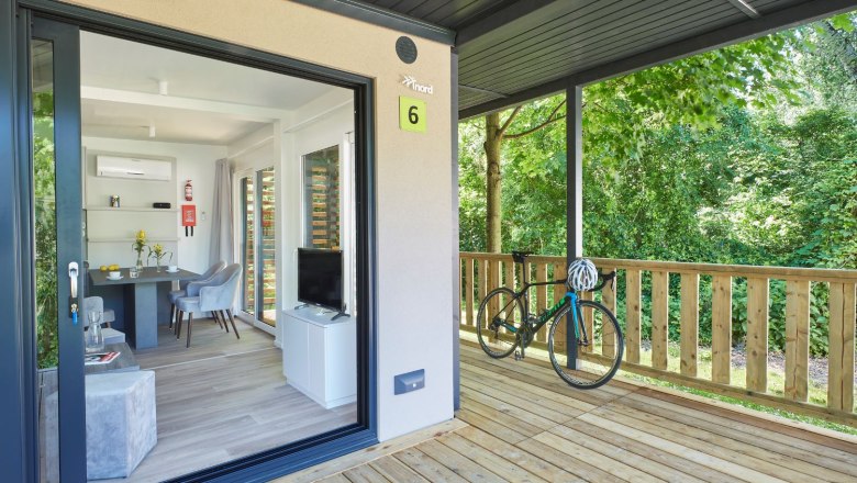 Entrance mobile home and bicycle standing on terrace