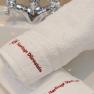 White towels with red lettering 'Heritage Dürnstein' on a washbasin with tap.