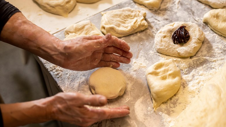 Prepare yeast dumplings on a floured work surface.