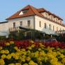 Hotel Geier in Bad Sch&ouml;nau with flower bed in the foreground.
