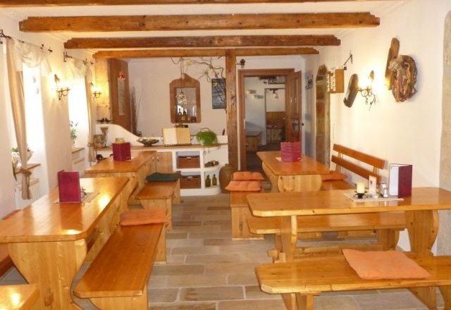 Interior view of a traditional wine tavern with wooden tables and benches.