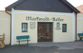 Entrance to the Markward cellar with benches and open gate.
