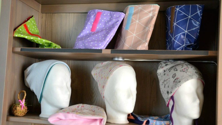 Shelf with handmade hats and bags.