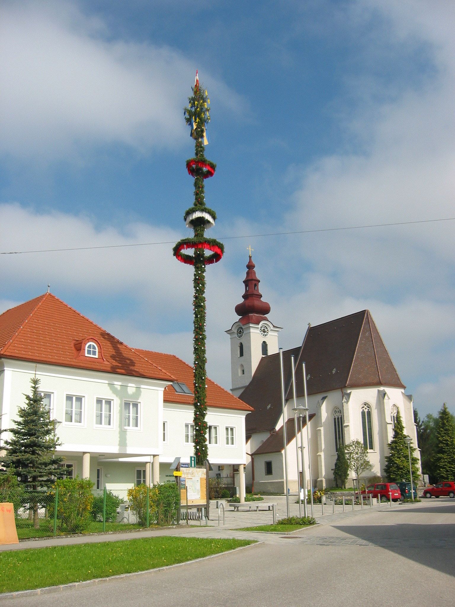 Church with onion dome and maypole in St. Pantaleon-Erla.