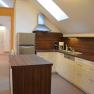 Modern kitchen with wooden worktops, skylight and appliances.