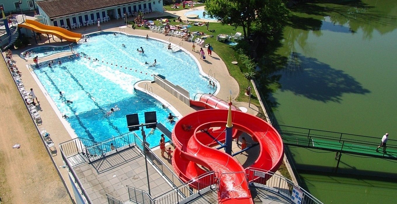 Aerial view of an outdoor pool with slides and swimming pool.